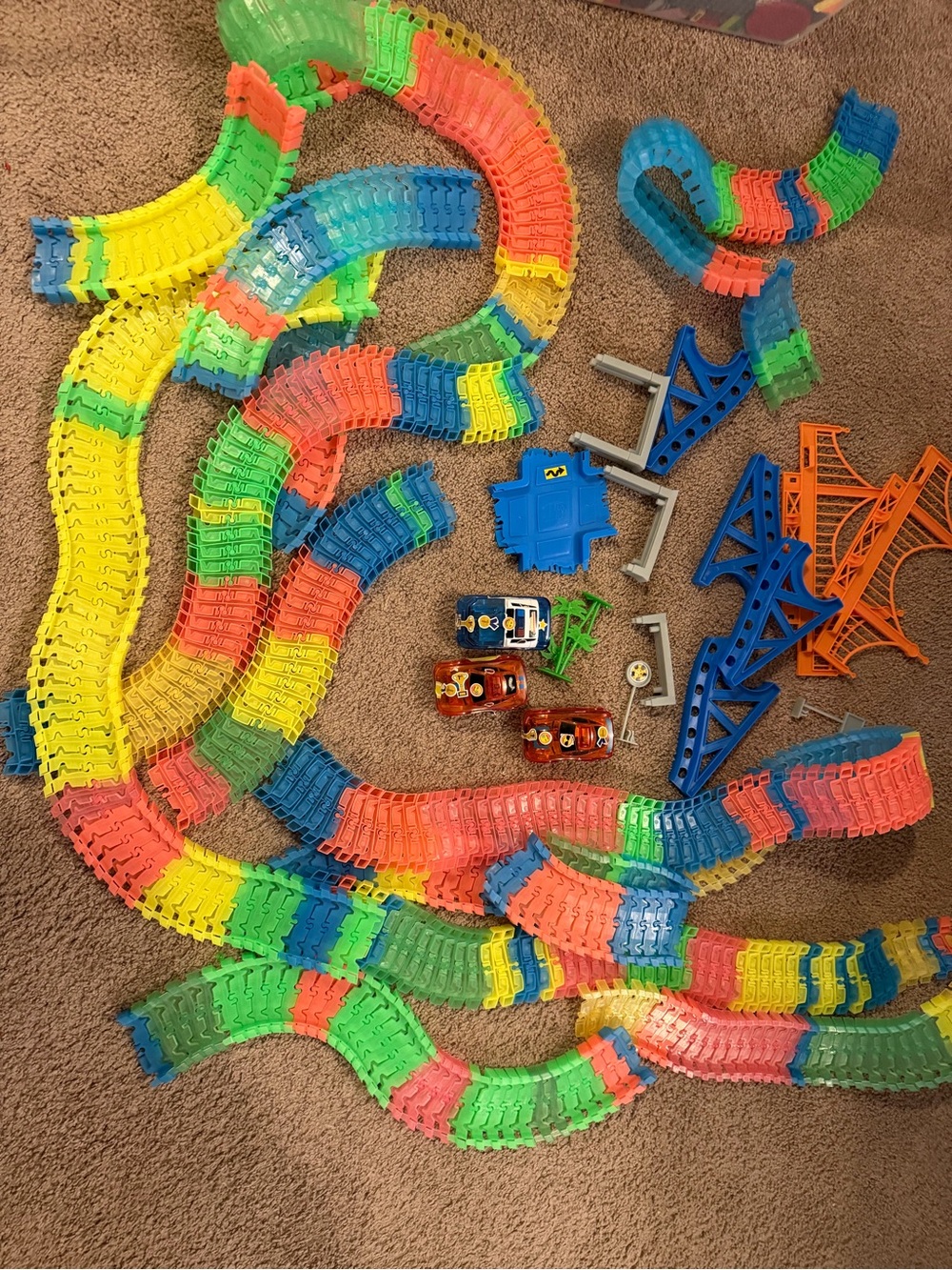 Lots of glow tracks, bridge, crossroad piece, and three working cars